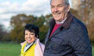 Picture of 2 smiling adults walking outside