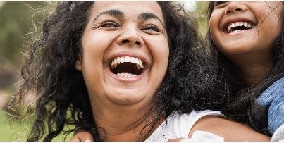 Head shots of an adult and child smiling