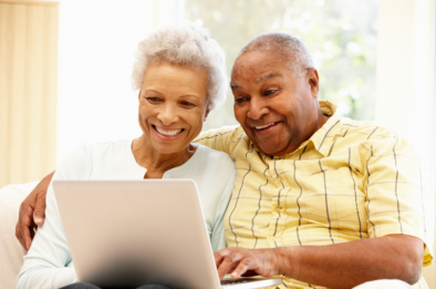 Older-couple-on-laptop-394x261 Picture of two people sat looking at a laptop screen and smiling