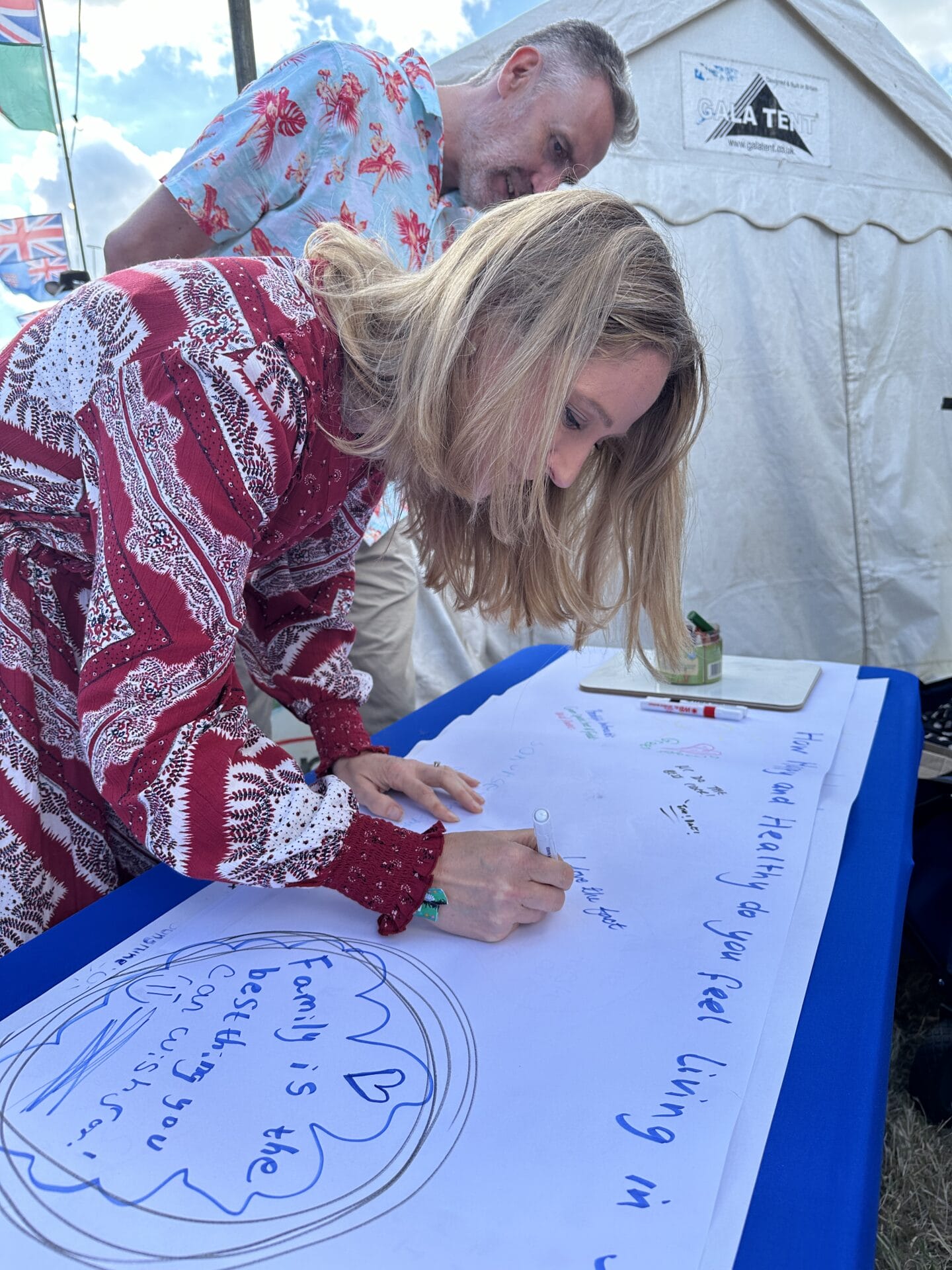 A young woman writing a message on a piece of paper. You can't read what it says