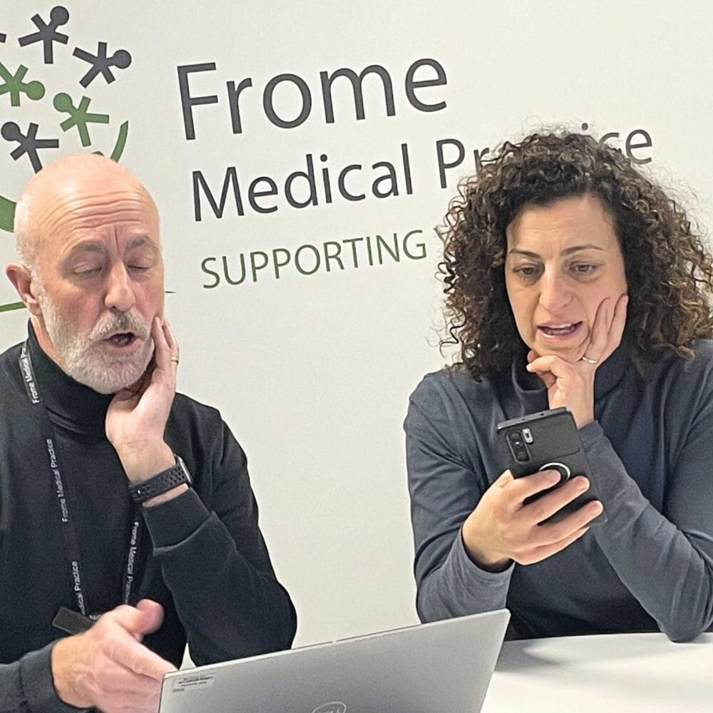 Photo of Will showing patient how to use NHS app